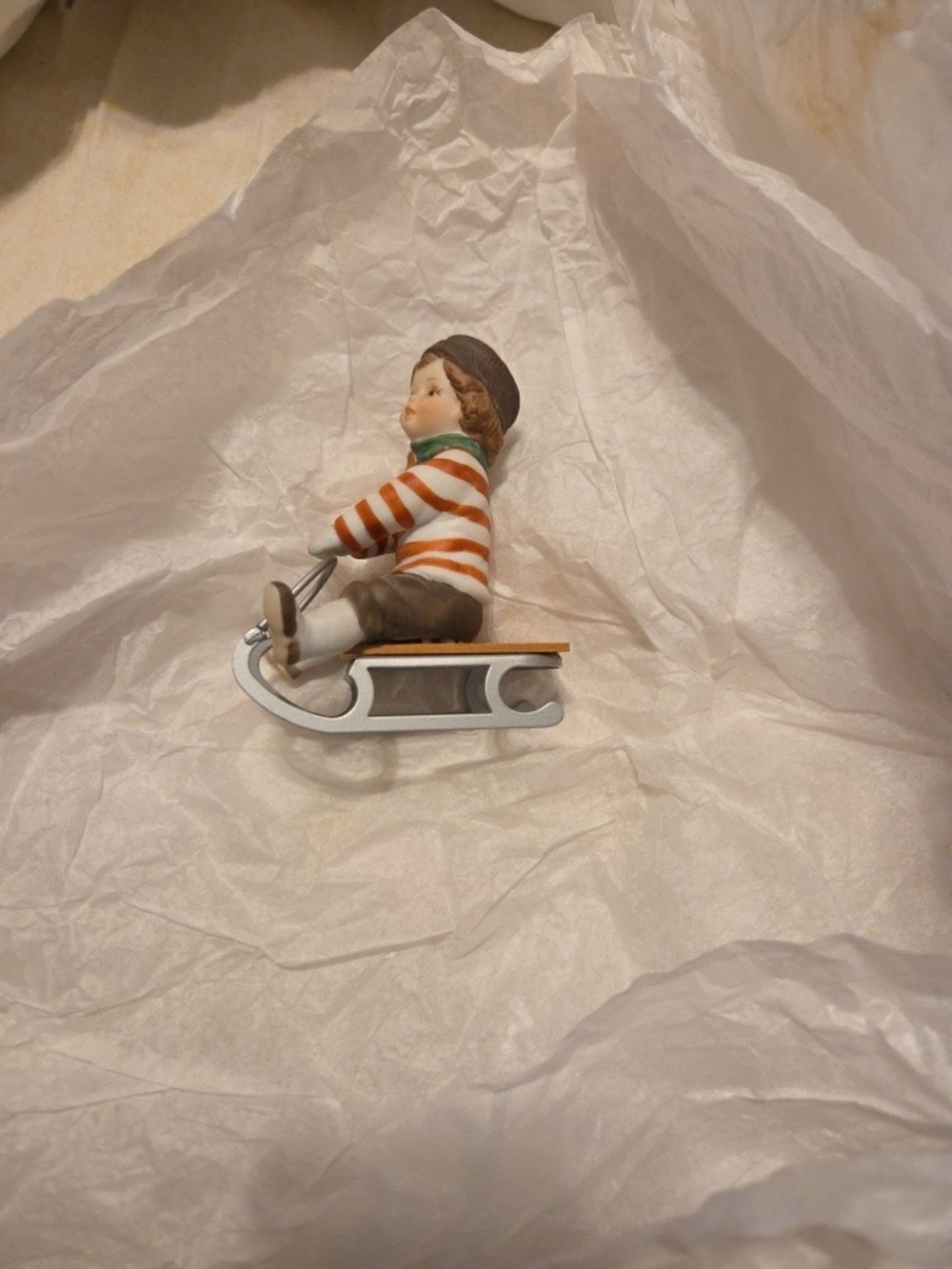 Enesco Boy on Sled Figurine with Orange-Striped Sweater and Silver Sled